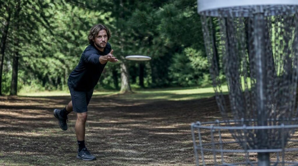 Joueur de disc golf lançant un disque